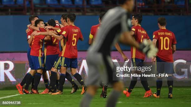 Cesar Gelabert of Spain is mobbed byteam mates after scoring his team's 2nd goal during the FIFA U-17 World Cup India 2017 group D match between...