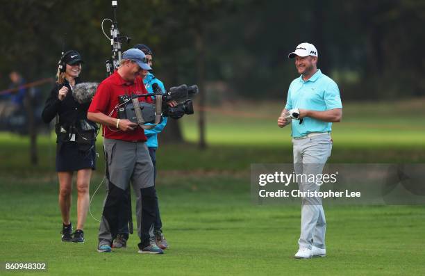 Jamie Donaldson of Wales smiles as he is filmed by a TV camera crew during day two of the Italian Open at Golf Club Milano - Parco Reale di Monza on...