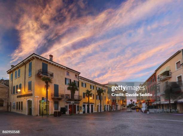 view of sirmione old town at sunrise - sirmione fotografías e imágenes de stock