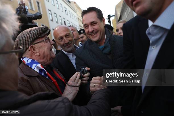 Heinz-Christian Strache, lead candidate of the right-wing Austria Freedom Party , greets supporters as he arrives to speak at the final FPOe election...
