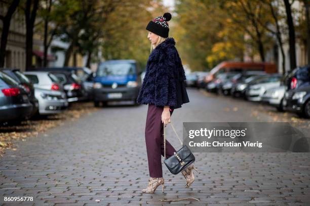 Sonia Lyson wearing Jimmy Choo boots with snake skin print, navy fake fur cropped jacket Nobi Talai, bordeaux pleated trousers Nobi Talai, wool...