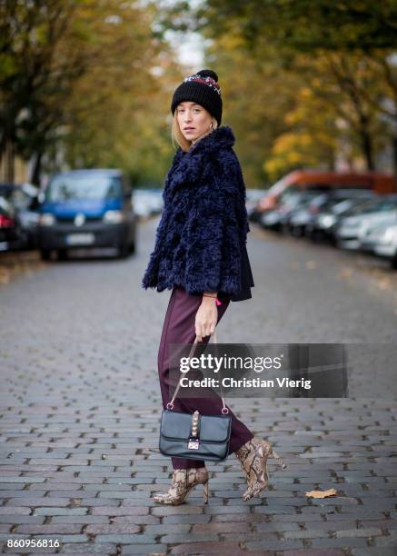 Sonia Lyson wearing Jimmy Choo boots with snake skin print, navy fake fur cropped jacket Nobi Talai, bordeaux pleated trousers Nobi Talai, wool...