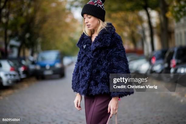 Sonia Lyson wearing Jimmy Choo boots with snake skin print, navy fake fur cropped jacket Nobi Talai, bordeaux pleated trousers Nobi Talai, wool...