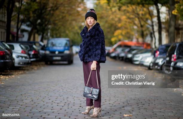 Sonia Lyson wearing Jimmy Choo boots with snake skin print, navy fake fur cropped jacket Nobi Talai, bordeaux pleated trousers Nobi Talai, wool...