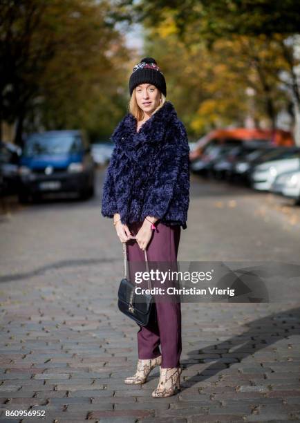 Sonia Lyson wearing Jimmy Choo boots with snake skin print, navy fake fur cropped jacket Nobi Talai, bordeaux pleated trousers Nobi Talai, wool...