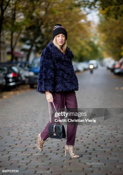 Sonia Lyson wearing Jimmy Choo boots with snake skin print, navy fake fur cropped jacket Nobi Talai, bordeaux pleated trousers Nobi Talai, wool...