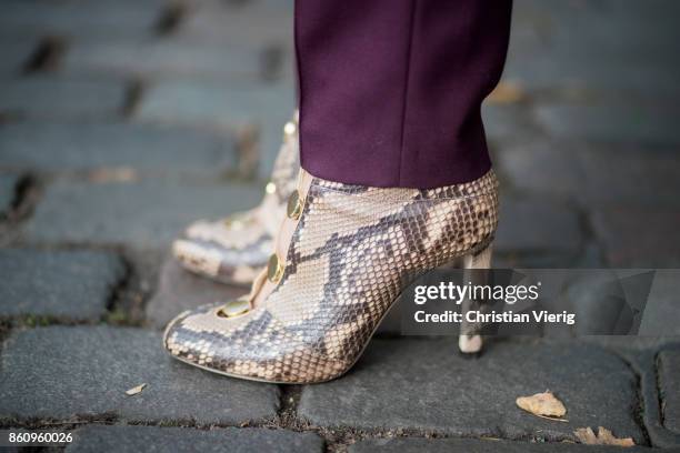 Sonia Lyson wearing Jimmy Choo boots with snake skin print, navy fake fur cropped jacket Nobi Talai, bordeaux pleated trousers Nobi Talai, wool...