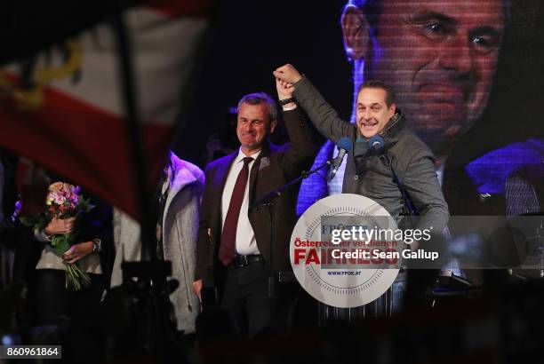 Heinz-Christian Strache , lead candidate of the right-wing Austria Freedom Party , and FPOe leading member Norbert Hofer celebrate after Strache...