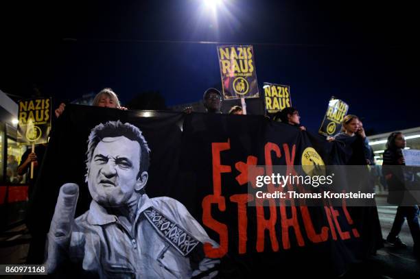 Demonstrators carry signs reading 'Nazis get out' and 'Fuck Strache!' during a protest on October 13, 2017 in Vienna, Austria. Austria will hold...