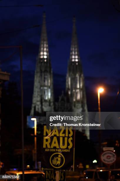 Sign is seen in front of the Votiv church reading 'Nazis get out' during a protest on October 13, 2017 in Vienna, Austria. Austria will hold...