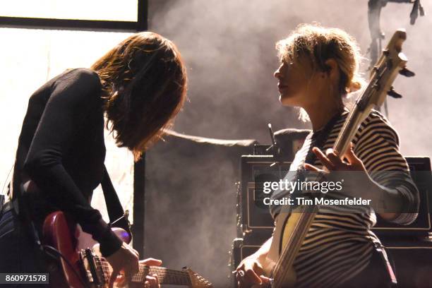 Theresa Wayman and Jenny Lee Lindberg of Warpaint perform during the "Global Spirit Tour" at ORACLE Arena on October 10, 2017 in Oakland, California.