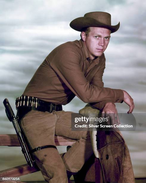 Portrait of American actor Steve McQueen , perched atop a fence, in the television series 'Wanted: Dead or Alive,' late 1950s or early 1960s.