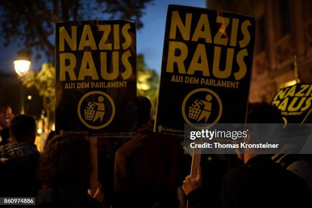 Demonstrators carry signs reading 'Nazis get out' during a protest on October 13, 2017 in Vienna, Austria. Austria will hold legislative elections on...