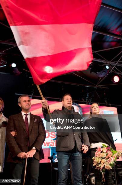 Leader of the right-wing Austrian Freedom Party Heinz-Christian Strache, waves a giant flag of his party next to his wife Philippa Beck and FPOe...