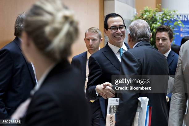 Steven Mnuchin, U.S. Treasury secretary, center, greets an attendee while walking to a Group of 20 finance ministers and central bank governors...