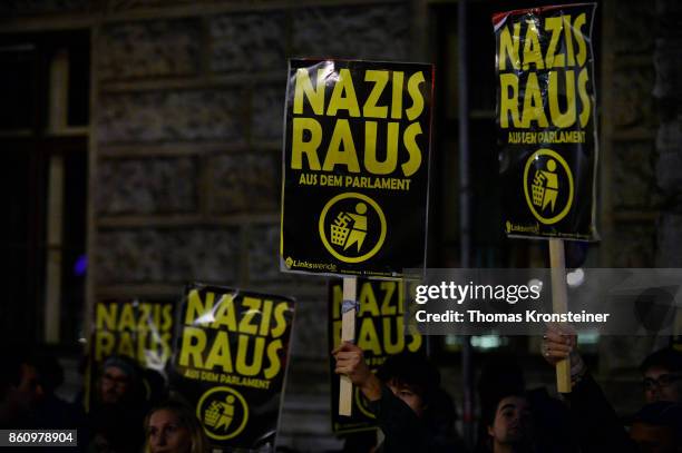 Demonstrators carry signs reading 'Nazis get out' during a protest on October 13, 2017 in Vienna, Austria. Austria will hold legislative elections on...