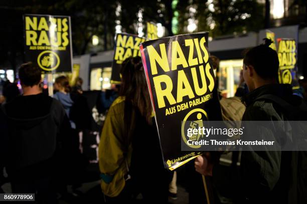 Demonstrators carry signs reading 'Nazis get out' during a protest on October 13, 2017 in Vienna, Austria. Austria will hold legislative elections on...