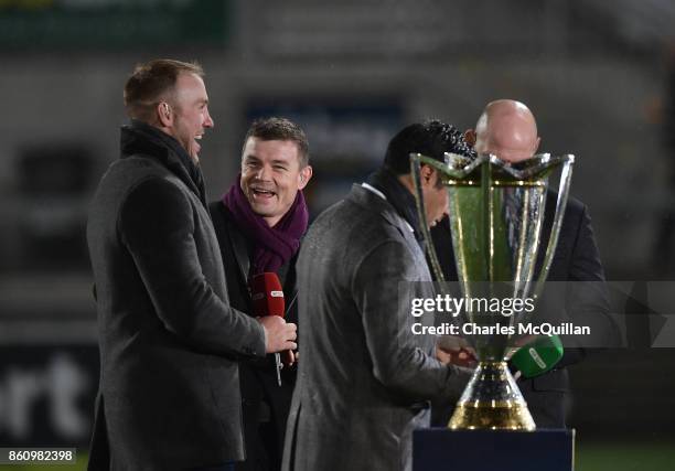 Former Ireland rugby players Brian O'Driscoll and Stephen Ferris joke with one another before the European Rugby Champions Cup match between Ulster...