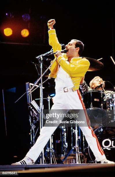 Freddie Mercury of Queen performs on stage with drummer Roger Taylor behind on the Magic Tour at Wembley Stadium, London, July 1986.