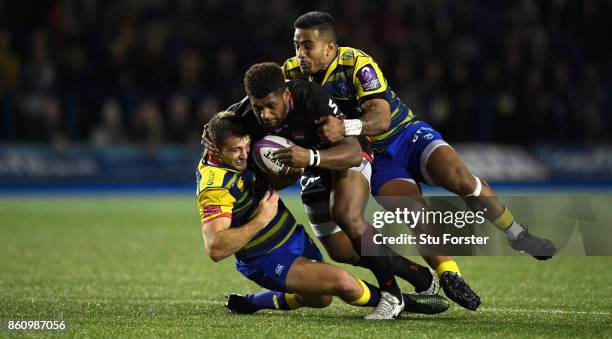 Lyon wing Timilai Rokoduru is sandwiched between Blues centres Garyn Smith and Rey Lee-Lo during the European Rugby Challenge CUP Match between...