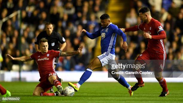 Isaac Vassell of Birmingham is tackled by Sean Morrison and Joe Ralls of Cardiff during the Sky Bet Championship match between Birmingham City and...