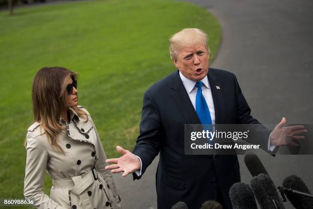 First Lady Melania Trump looks on as U.S. President Donald Trump takes questions from reporters, on their way to Marine One on the South Lawn of the...