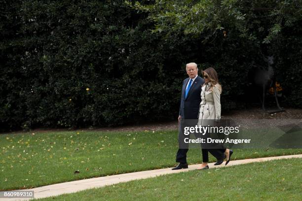 First Lady Melania Trump and U.S. President Donald Trump walk to Marine One on the South Lawn of the White House, October 13, 2017 in Washington, DC....