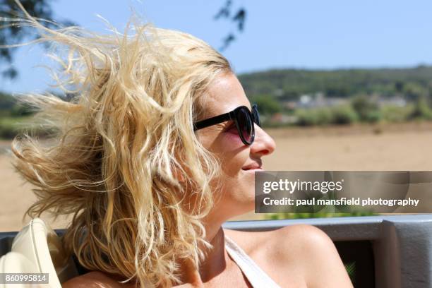 mature blond lady with windswept hair - open top bus stock pictures, royalty-free photos & images