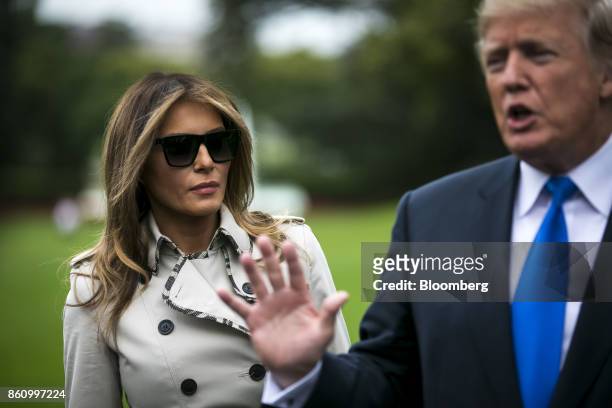 First Lady Melania Trump, left, listens as U.S. President Donald Trump speaks to members of the media before boarding Marine One on the South Lawn of...