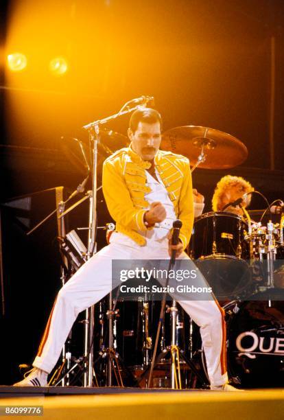 Freddie Mercury of Queen performs on stage with drummer Roger Taylor behind on the Magic Tour at Wembley Stadium, London, July 1986.