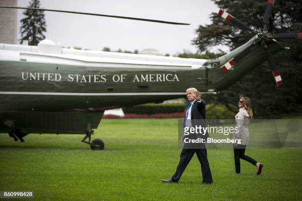 President Donald Trump, left, waves while walking with First Lady Melania Trump to board Marine One on the South Lawn for Beltsville, Maryland, in...