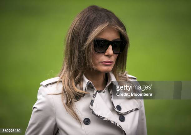 First Lady Melania Trump listens as U.S. President Donald Trump, not pictured, speaks to members of the media before boarding Marine One on the South...