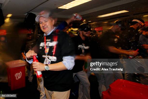 Chicago Cubs owner Tom Ricketts celebrates in the clubhouse after winning Game 5 of the National League Division Series 9-8 against the Washington...