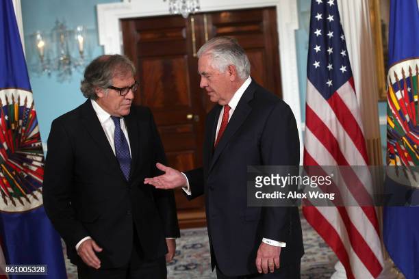 Secretary of State Rex Tillerson extends his hand for a hand shake with Organization of American States Secretary General Luis Almagro at the State...