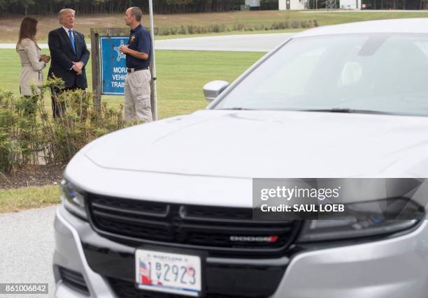 President Donald Trump and First Lady Melania Trump watch a vehicle demonstration at the United States Secret Service James J. Rowley training...