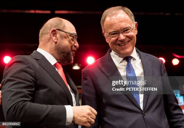 Social Democratic Party 's current state premier in Lower Saxony, Stephan Weil shaked hands with SPD leader Martin Schulz during a campaign meeting...