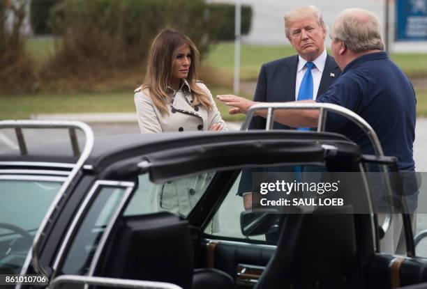 President Donald Trump and First Lady Melania Trump look at a 1983 Cadillac limousine used by former President Ronald Reagan at the United States...