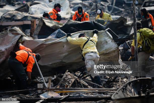 Search and Rescue personnel look for human remains in the Journey's End Mobile Home park following the damage caused by the Tubbs Fire on October 13,...