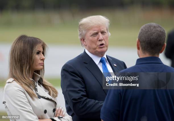 President Donald Trump, center, and U.S. First Lady Melania Trump speak with an employee while touring the U.S. Secret Service James J. Rowley...