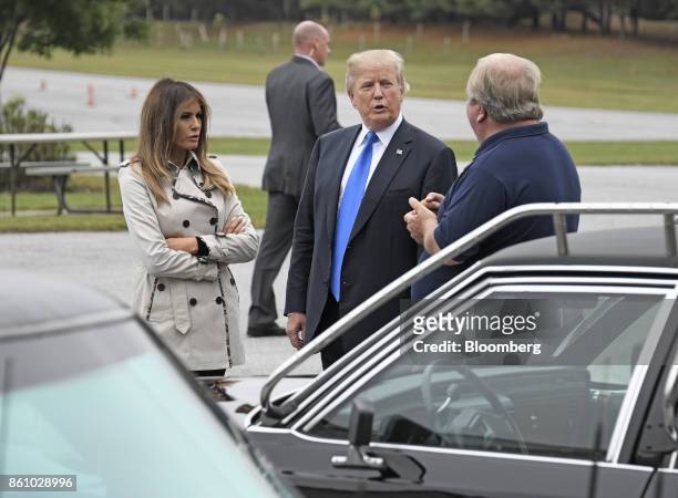 President Donald Trump, center, and U.S. First Lady Melania Trump speak with an employee while touring the U.S. Secret Service James J. Rowley...
