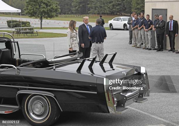 President Donald Trump, center, and U.S. First Lady Melania Trump speak with an employee while touring the U.S. Secret Service James J. Rowley...