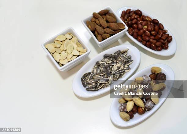various nuts on a table - sunflower seed oil stock pictures, royalty-free photos & images