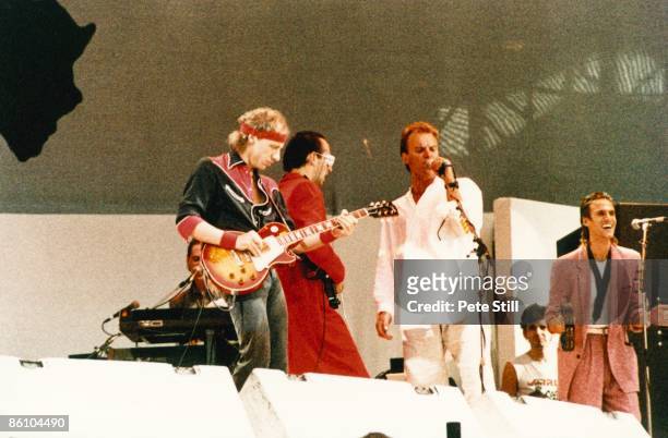 Photo of Chris WHITE and LIVE AID and DIRE STRAITS and STING and Mark KNOPFLER and Jack SONNI, w/ Sting - L-R: Mark Knopfler, Jack Sonni, Sting,...