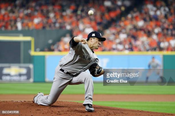 Masahiro Tanaka of the New York Yankees pitches in the first inning against the Houston Astros during game one of the American League Championship...