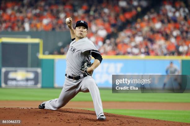 Masahiro Tanaka of the New York Yankees pitches in the first inning against the Houston Astros during game one of the American League Championship...