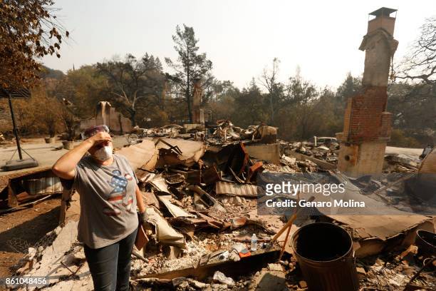 Lola Cornish stands in the rubble of her grandfather home victim to the Atlas fire in Napa on October 13, 2017. Residents were allowed to return to a...