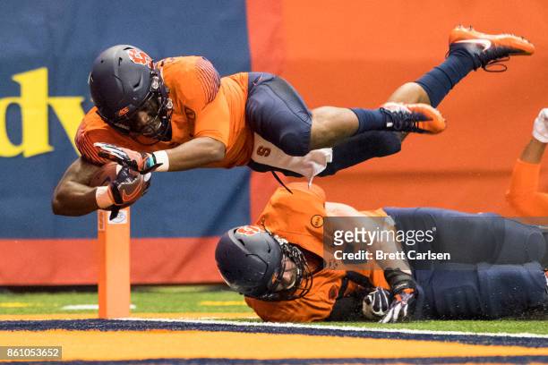 Dontae Strickland of the Syracuse Orange dives into the end zone for a touchdown during the first quarter against the Clemson Tigers at the Carrier...