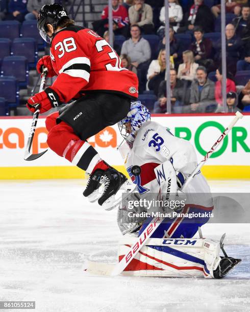 Bracken Kearns of the Binghamton Devils screens goaltender Charlie Lindgren of the Laval Rocket during the AHL game at Place Bell on October 13, 2017...