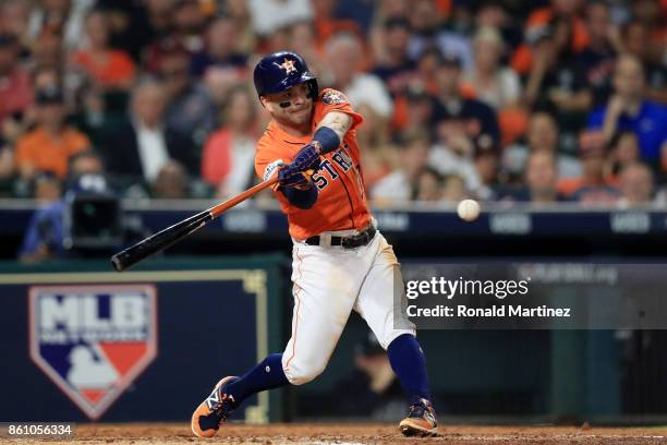 Jose Altuve of the Houston Astros hits a single in the fourth inning against the New York Yankees during game one of the American League Championship...