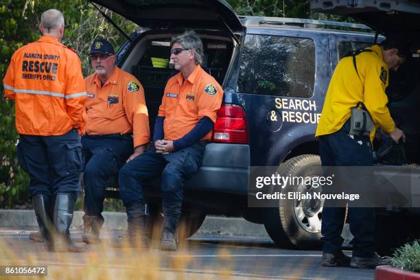 Search and Rescue personnel take a break while searching for human remains in the Journey's End Mobile Home park on October 13, 2017 in Santa Rosa,...